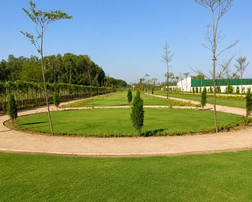 Landscaped green park with walking paths at Eldeco Viviana Ludhiana